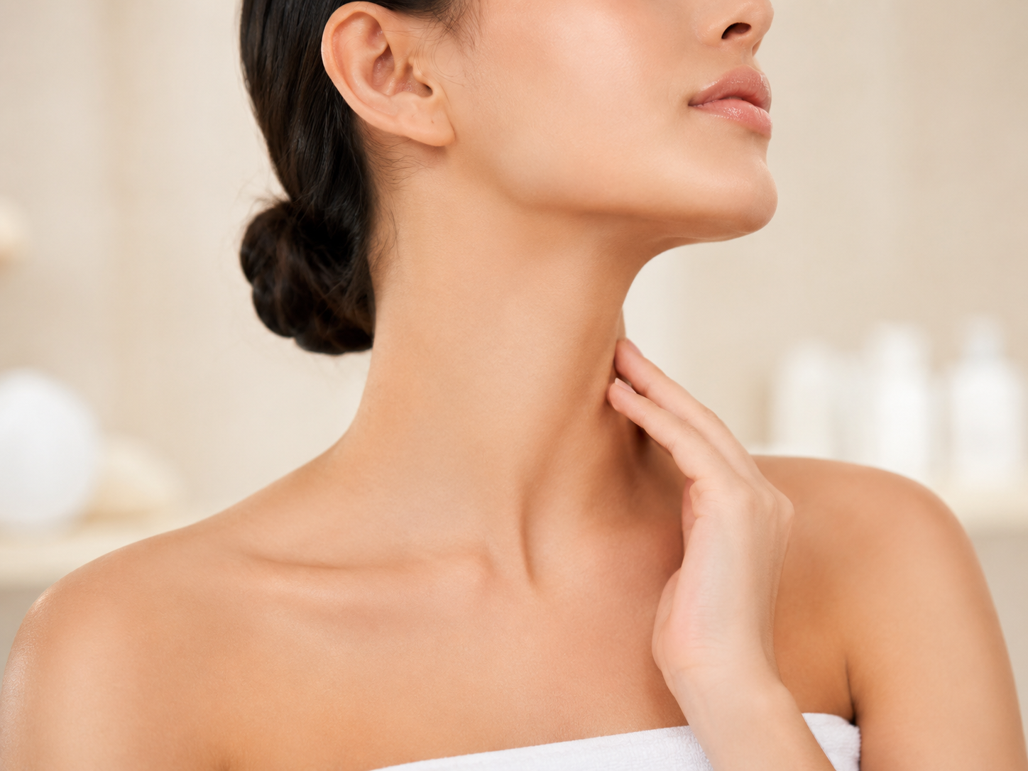 Neck: Close-up of a woman gently touching her neck, highlighting smooth, firm-looking skin.